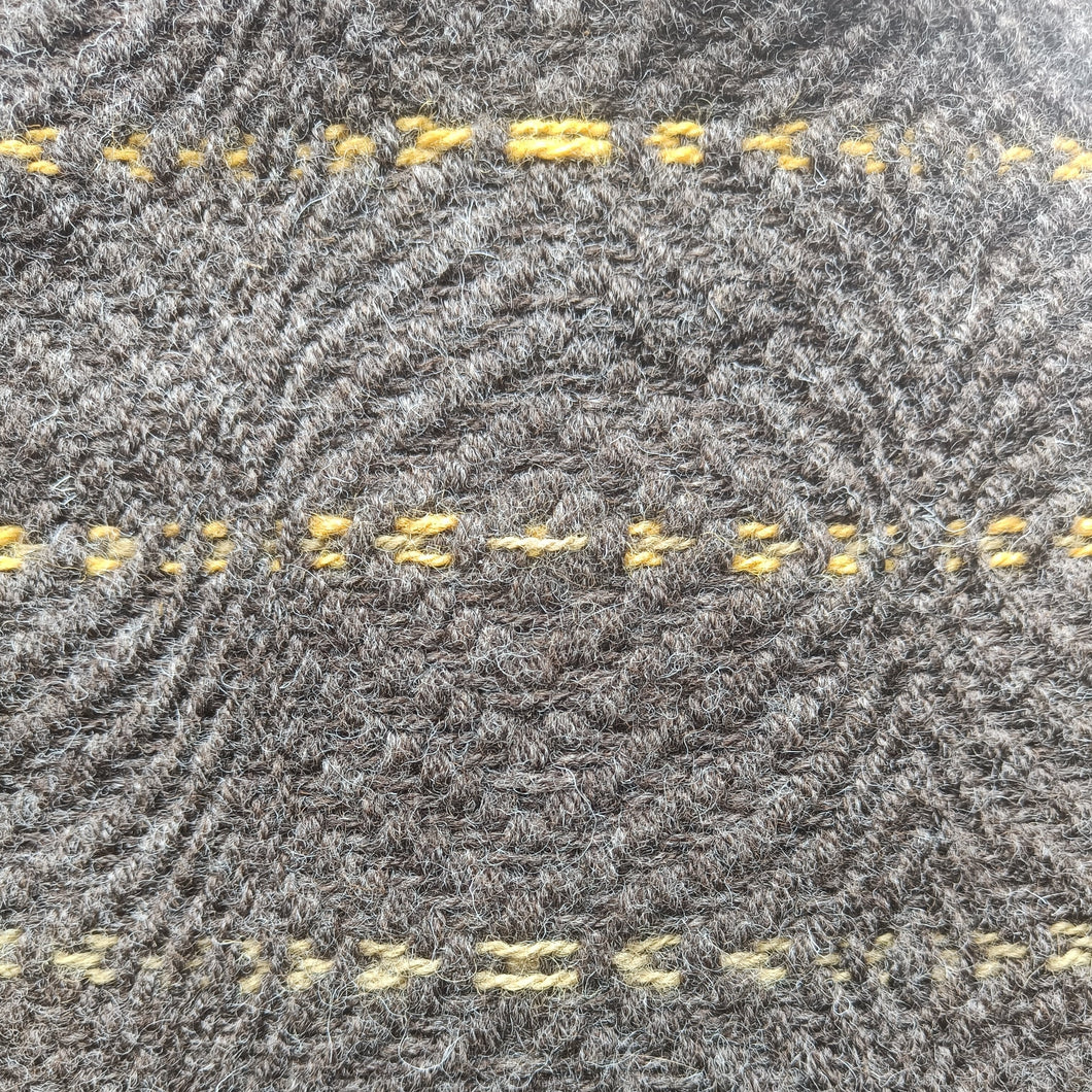 Brown jacob wool in circular pattern with yellow highlights 