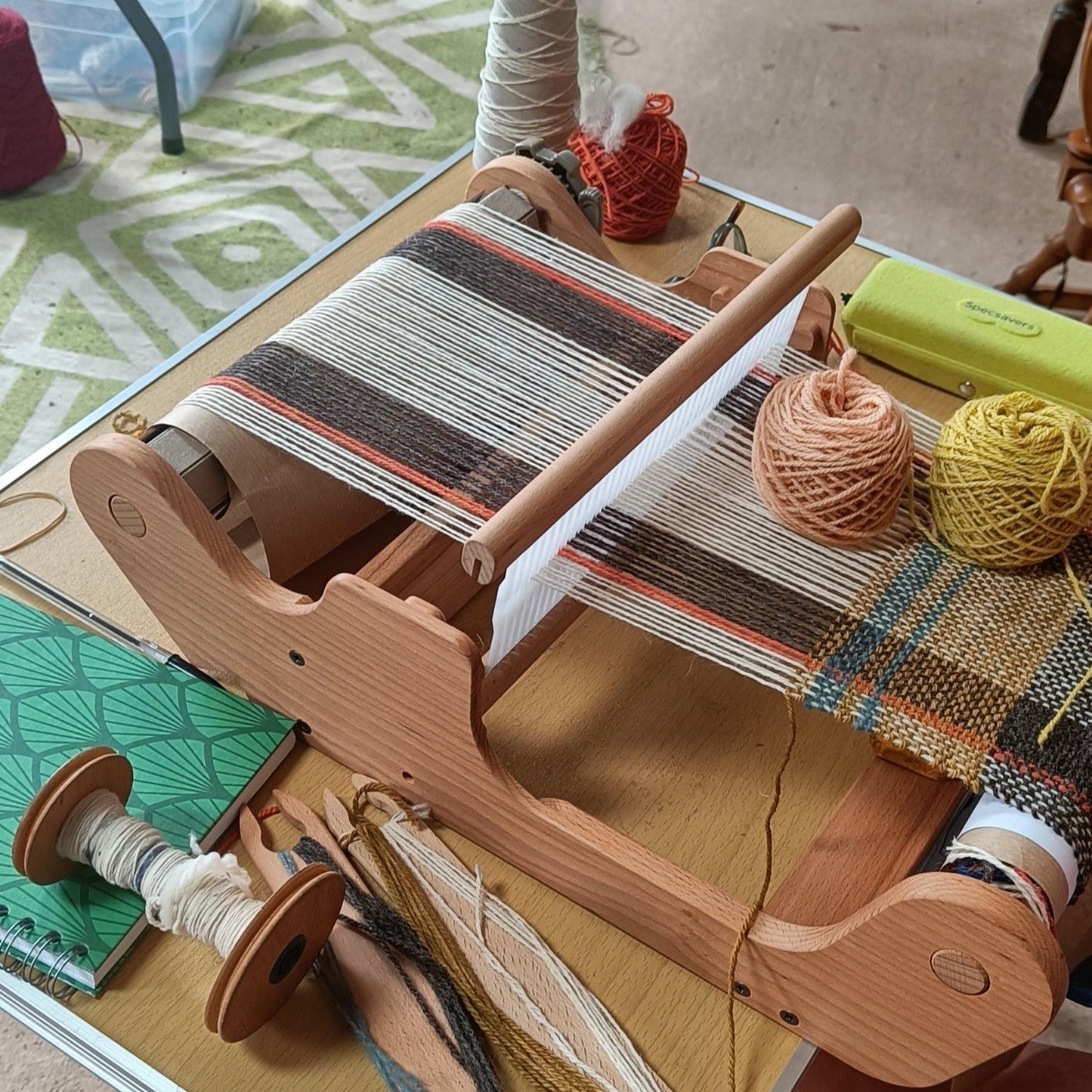 Wooden weaving loom with yarn on a table